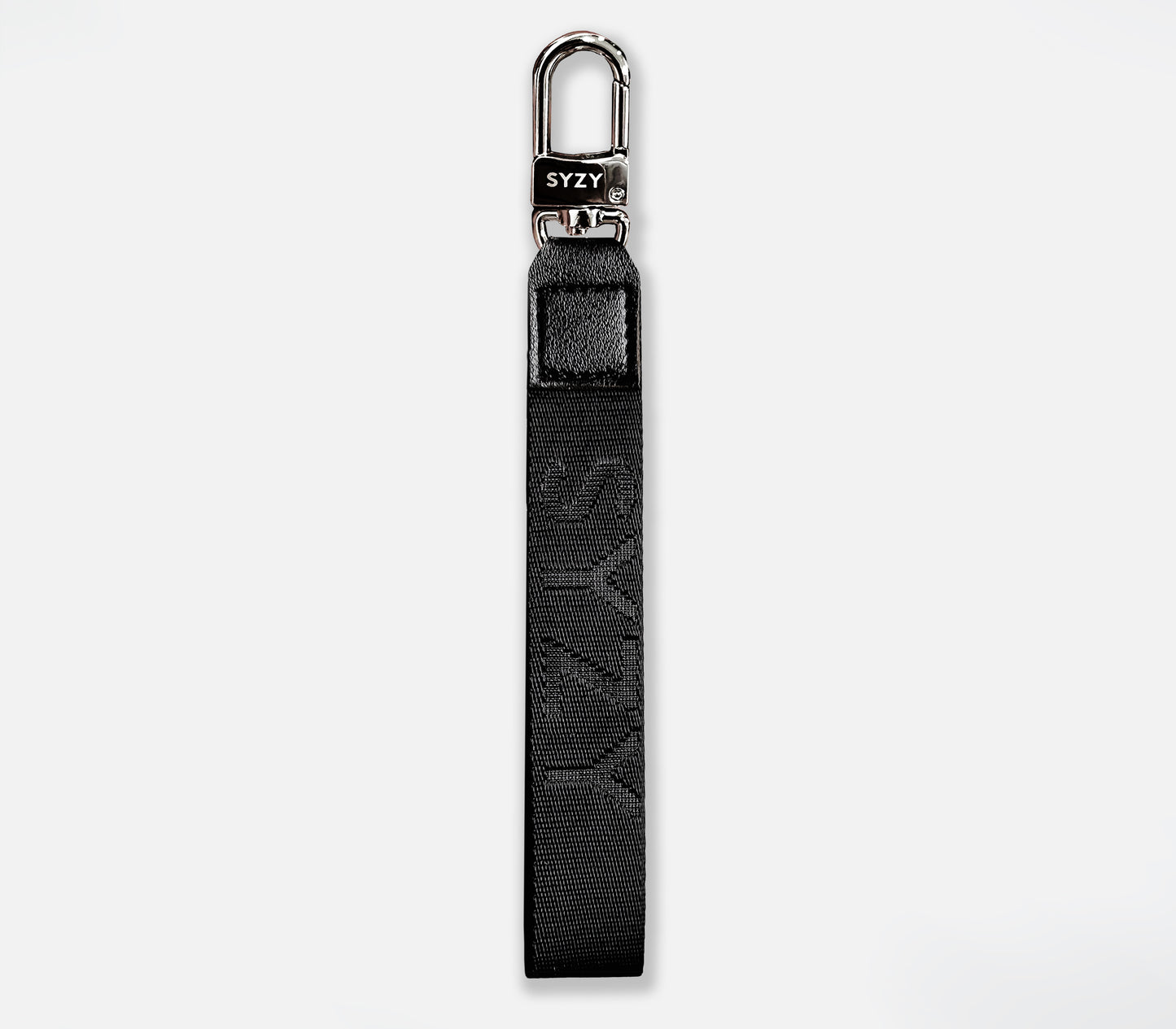 Close-up of a black SYZY Syndeo wrist strap with a silver clasp, featuring the SYZY logo.
