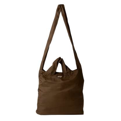 A Burnt Umber SYZY Tetra Tote Bag with multiple straps to carry is displayed on a white background