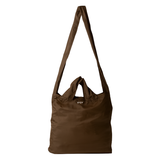 A Burnt Umber SYZY Tetra Tote Bag with multiple straps to carry is displayed on a white background