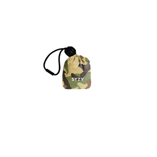 SYZY Stock Camo Tetra Tote Bag is stored inside a compact camo pouch with a drawstring against a transparent background.