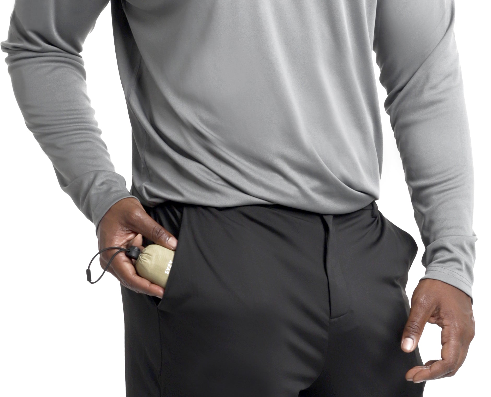 A man putting a TETRA Tote pouch in his pocket.